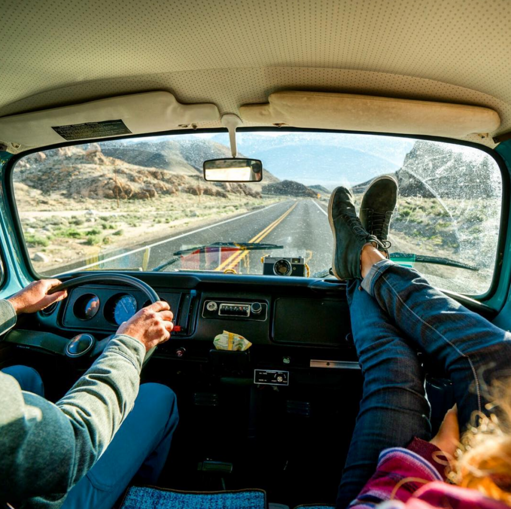 Chris Burkard man and woman driving in van on road